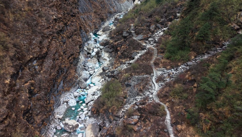 Drive to Tatopani (1,190 m), trek to Narchyang (1,510 m)